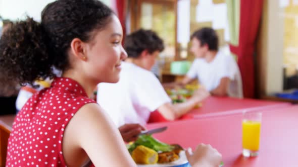 Schoolgirls having lunch in canteen 4k