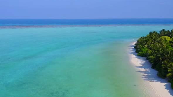 Aerial texture of seashore beach by blue sea with sand background