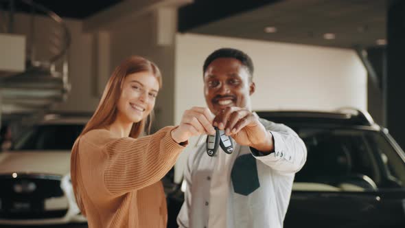 Close Up of Happy Multicultural Couple Posing at Modern Dealership Center with