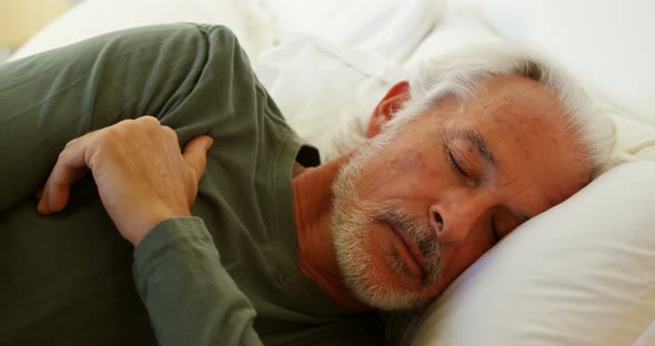 Senior man sleeping on bed in bedroom at home 4k