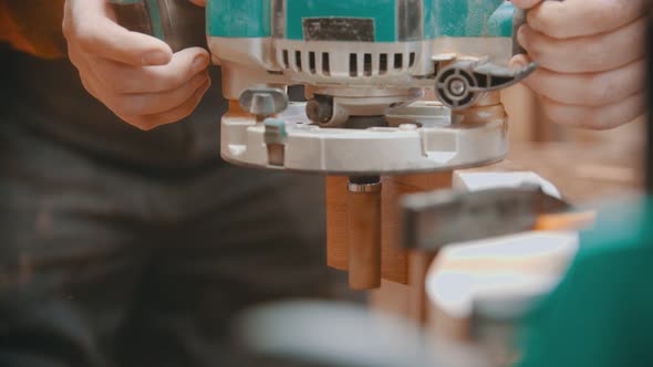 Woodworker Taking Off a Polishing Machine From the Detail