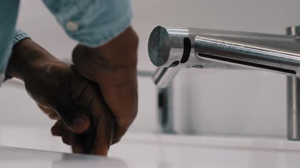 Closeup Unrecognizable African American Married Man Guy Using Washbasin Automatic Tech in Public