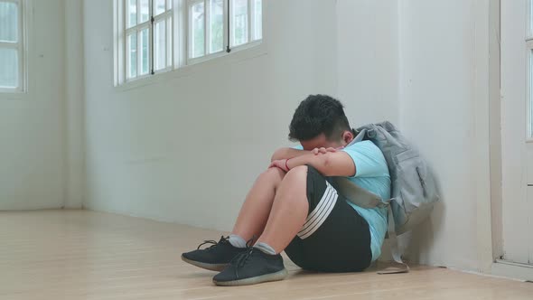 Asian Little Boy Sitting Alone With Sad Feeling At School. Bullying, Discrimination And Racism