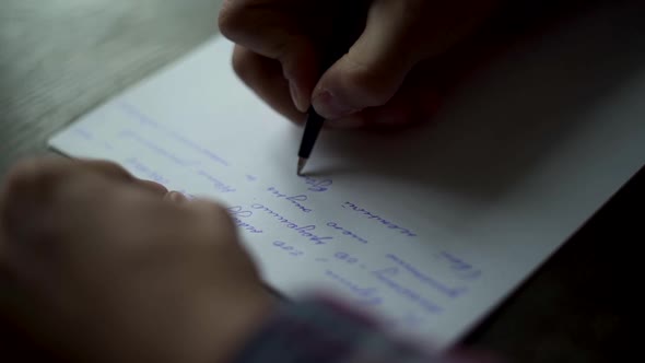 Man’s hands writing vintage letter on white paper on brown wooden table.  Grooms vow, 