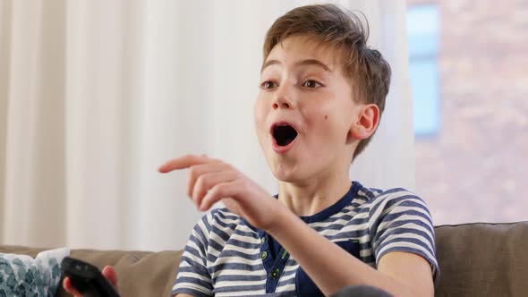 Boy with Popcorn Watching Tv at Home