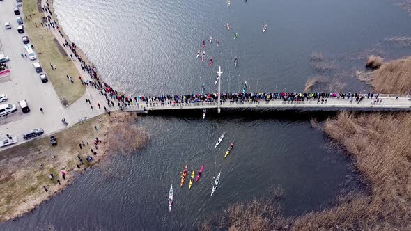 Aerial Bird Eyes View of Young Canoers Going Down Through the Bridge