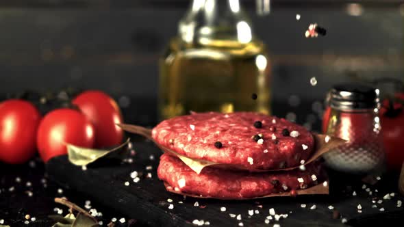 Super Slow Motion Spices Fall on the Raw Burger
