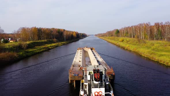 Aerial view:Barge on the River. Autumn Landscape, River Canal Near the Forest