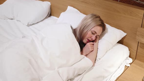 Sick Woman Sleeping in Bed On Side Cough