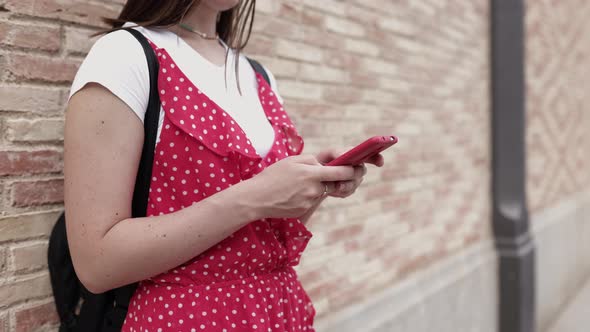 Side View Woman Using Smart Phone in the Street