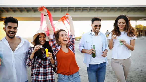 Happy Group of Young People Having Fun on Beach