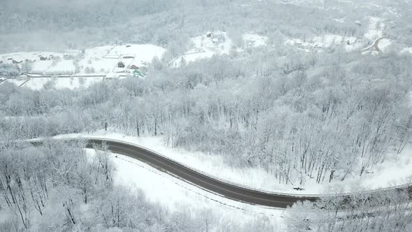 Drones Eye View  Winding Road From the High Mountain Pass in Winter