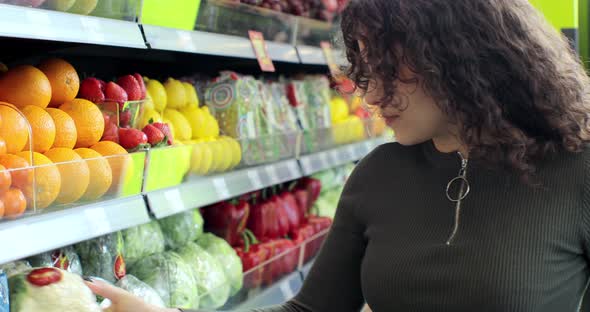 Close Up of Woman Selecting Fresh Orange in Grocery Store Supermarket Sale Shopping Marketplace