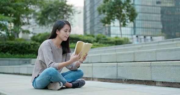 Woman Read Book in City