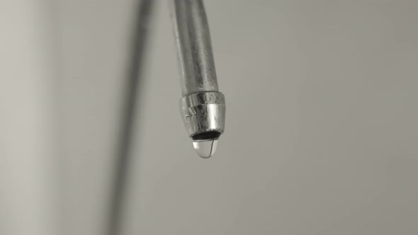 Macro Dripping Tap of Drinking Water in the Kitchen Leakage of the Main Resource of the Planet