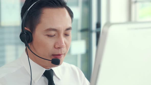 Businessman Wearing Headset Working Actively in Office