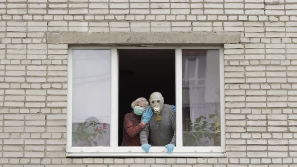 Old Grandparents Stay at Window Isolated at Home on Quarantine. Coronavirus
