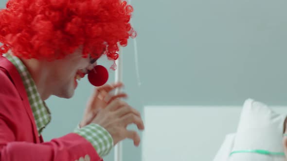 Hospital Clown Making Young Female Patient Laugh