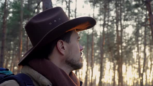 A Man with a Hat in the Forest