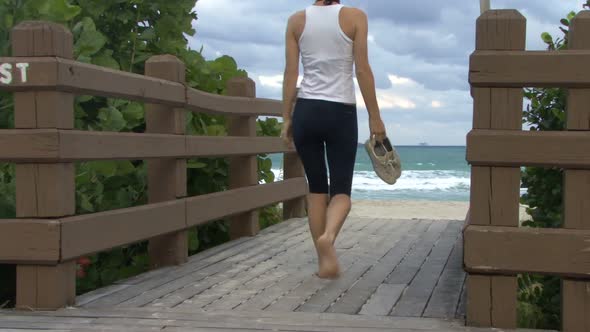 Female walking onto beach