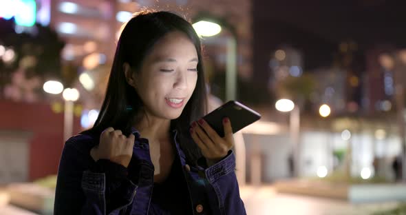 Woman work on cellphone at night