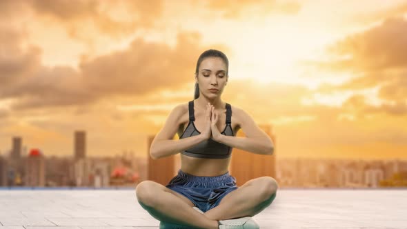 Portrait of a Dreamy Cute Woman Meditating Outdoors with Eyes Closed, with the Effect of Bokeh. City