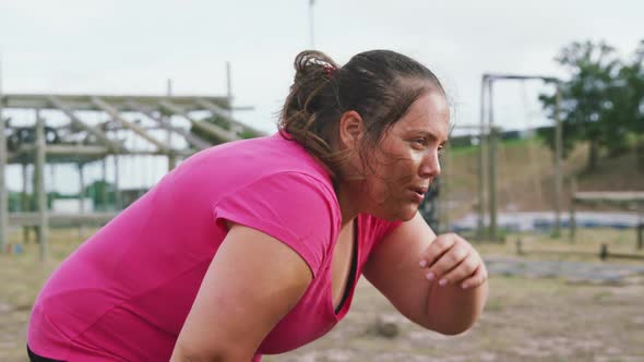 Caucasian woman tired after exercising at bootcamp