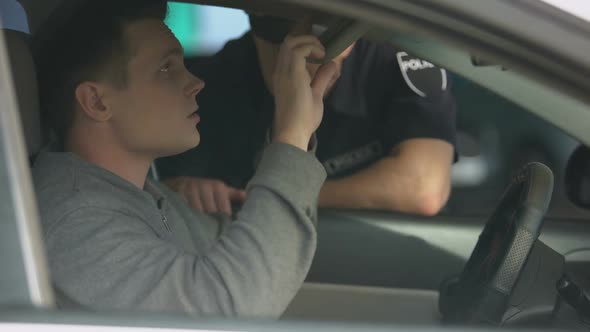 Young Male Driver Giving Documents to Police Officer, Traffic Control, Rules