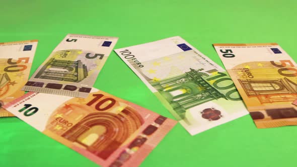 Closeup on a Green Gambling Table Scattered Euro Money Bills