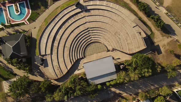 A dynamic pivoting aerial shot above the Villa Maria amphitheater in Córdoba City of Argentina while