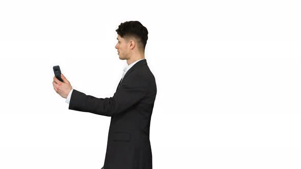 Young Business Man Walking and Taking a Selfie on White Background.