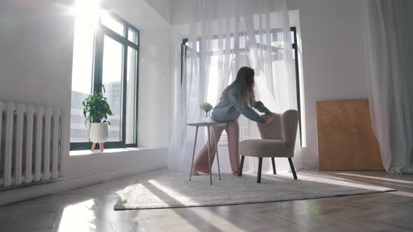 Modern Dancing  a Young Woman with Beautiful Long Hair Dancing Around the Spacious Apartment