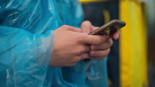 Closeup Male Hands Typing on Smartphone Touchscreen Outdoors