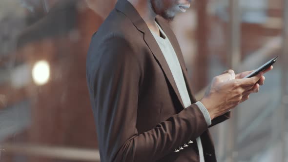 Midsection of African American Businessman Using Smartphone in Office