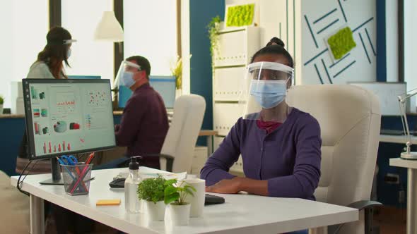 Black Employee with Visor Looking Serious at Camera