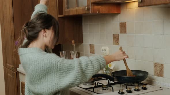 Young Woman Dancing and Having Fun While Prepares Food in the Kitchen