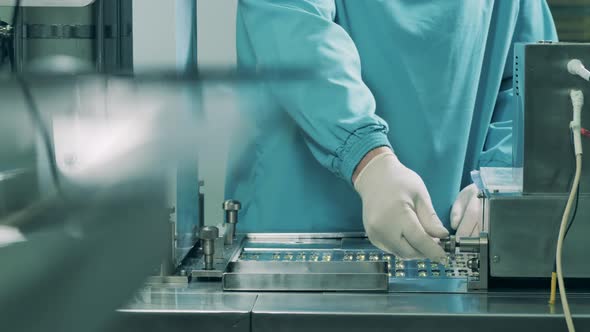 Production of Medicines at a Pharmaceutical Production Factory. Factory Worker Is Managing 