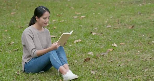 Young Woman Read a Book at Park