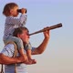 Grandfather and boy with telescope having fun outddor against blue summer sky - VideoHive Item for Sale