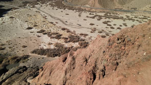 A drone flies backward over the rocky desert cliffs of Afton Canyon in the Mojave Desert of Californ