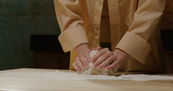 Woman's Hands Making Dough for Homemade Pizza