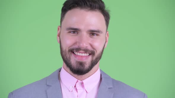 Face of Happy Young Handsome Bearded Businessman Smiling