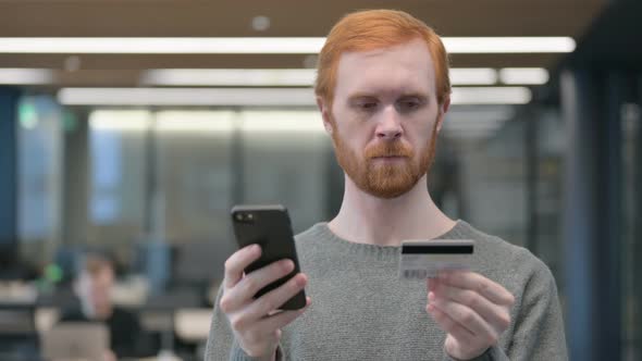 Portrait of Young Man Making Online Payment on Smartphone