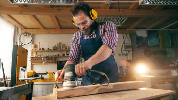 Craftsman Is Using a Buffing Machine To Work with Wood in Slow Motion