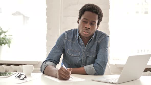 African Man Writing Letter