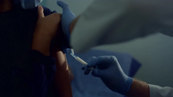 Closeup Doctor Hands Injecting Vaccine to African Girl