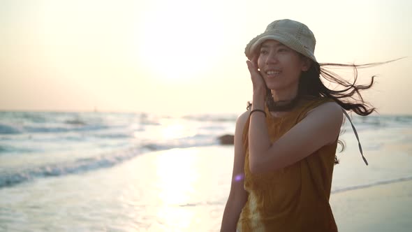 Asian woman happy and relaxing in freedom vacation time at the tropical san beach