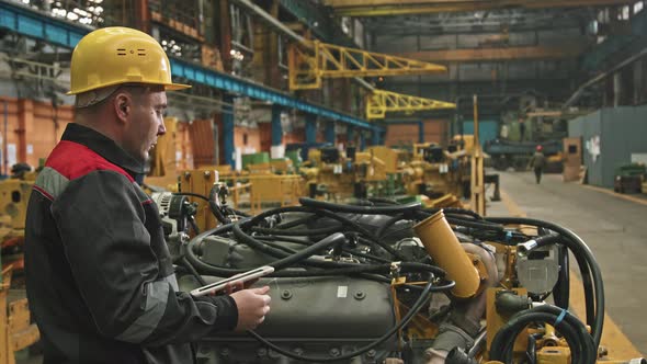 Plant Engineer Fixing Machinery In Assembly Shop