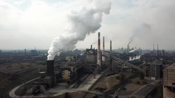 Aerial view over industrialized city with air atmosphere from metallurgical plant.