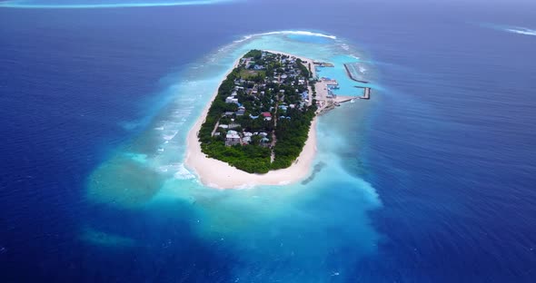 Daytime overhead abstract view of a white paradise beach and blue water background in 4K